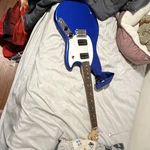 Squier Blue Electric Guitar Dual Humbucker White Pickguard Maple Neck Strap. Fixed Price $200.00.